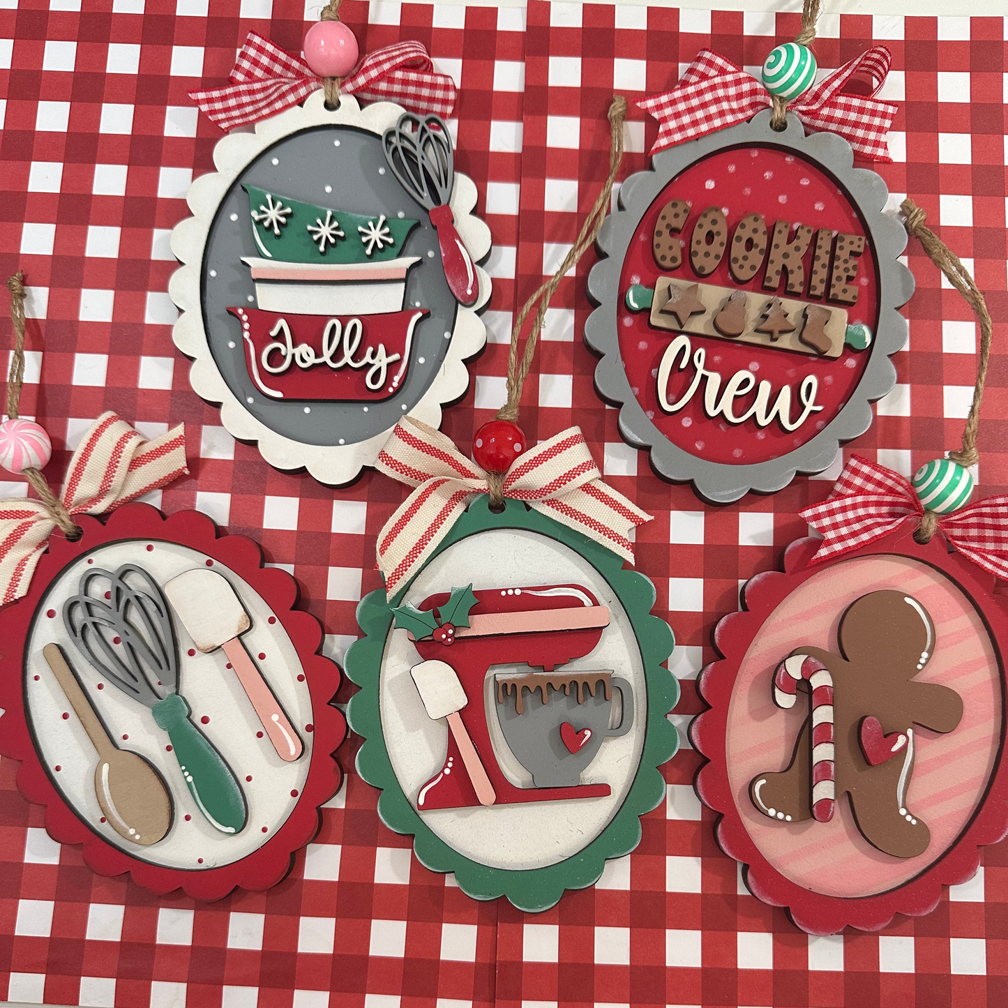 Set of Christmas-themed decorative tags on a red and white checkered background